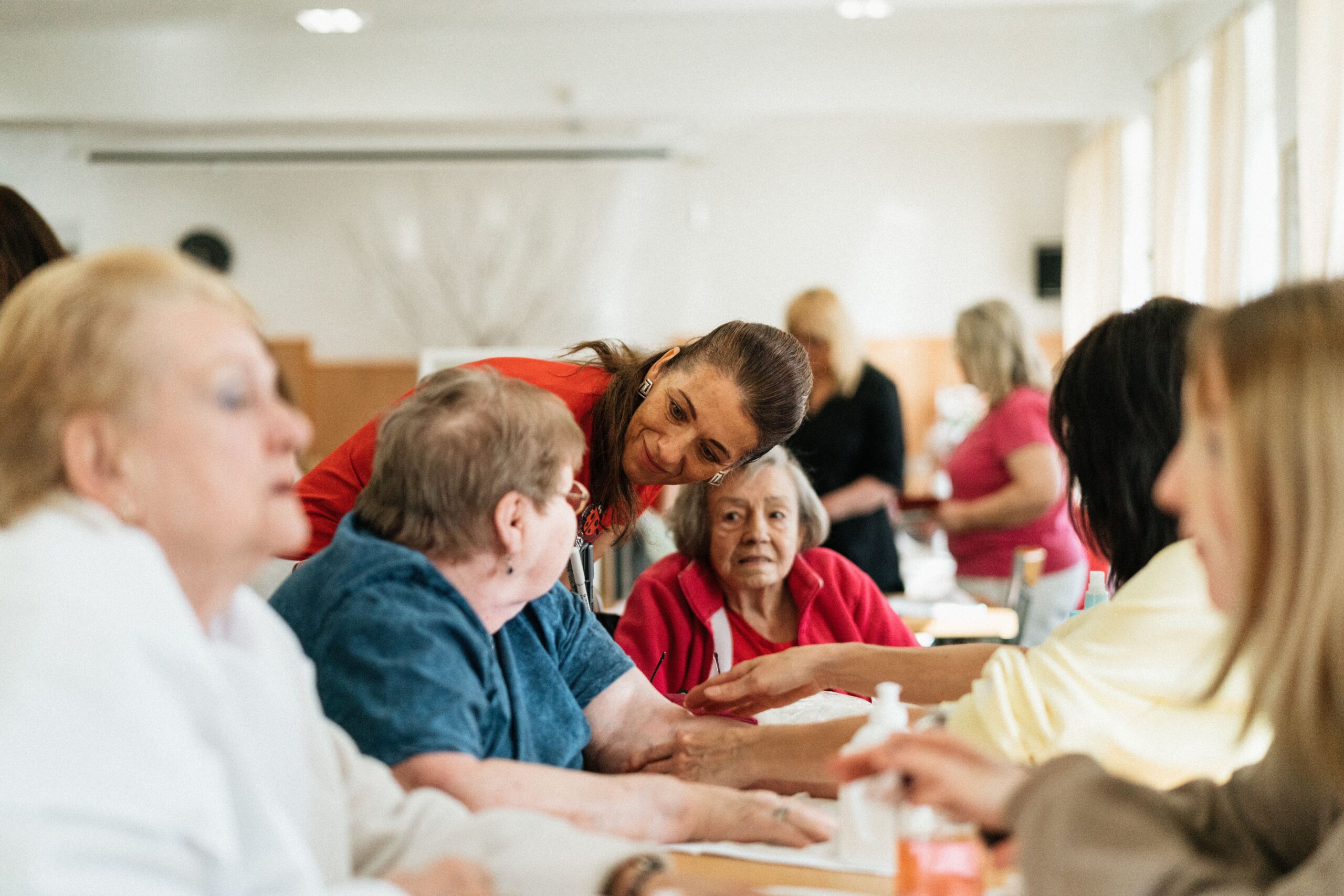 Older adults and caregivers gathering together, featured on the Parker’s Place About Us page